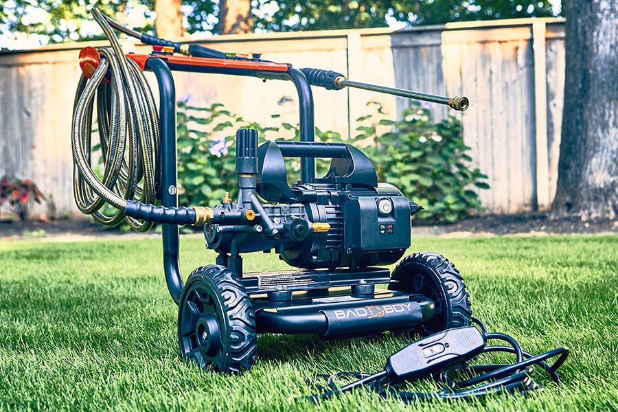 Garden hose reel with hose on a grassy lawn